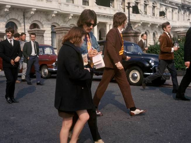 George Harrison signing an autograph while he and his band were filming 'Magical Mystery Tour', in September 1967