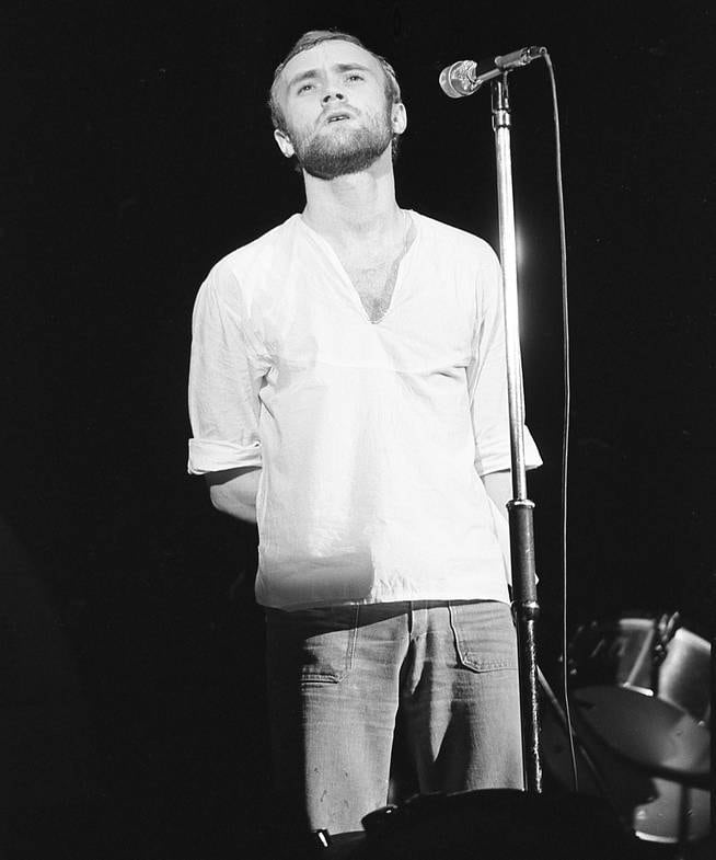 Genesis drummer Phil Collins takes the stage to sing "More Fool Me"  during a 1974 concert in New York