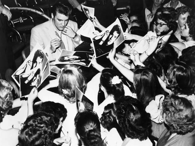 Elvis Presley signing autographs