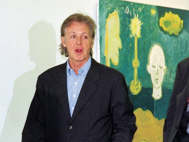 Paul McCartney in the gallery that exhibited his paintings in 1999