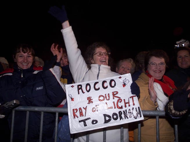 Dornoch residents celebrate the arrival of guests at the baptism of Rocco, Madonna's son