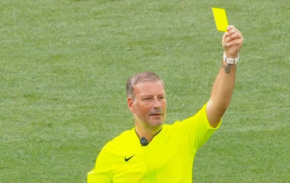 A Soccer Player Receives A Yellow Card